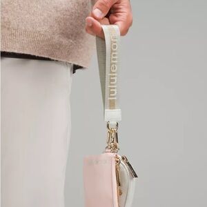 72 Lululemon Dual Pouch Wristlet Wordmark - Vapor Gold White
